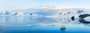 Sunset over a three mast tall ship panoramic